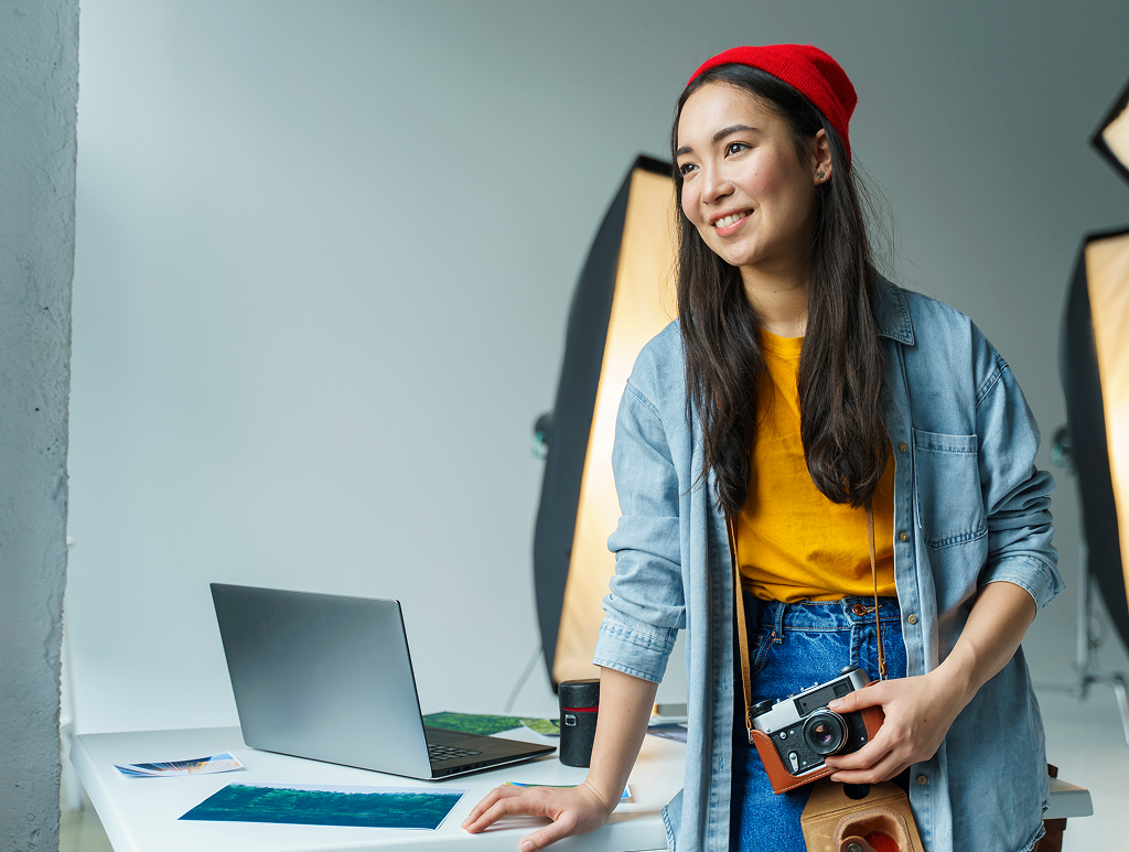 Smiling young woman working indoors at her office desk